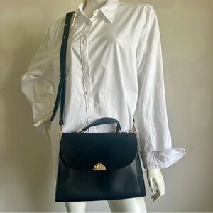 Elegant Black Faux Leather and Suede Handbag with Gold-look accents